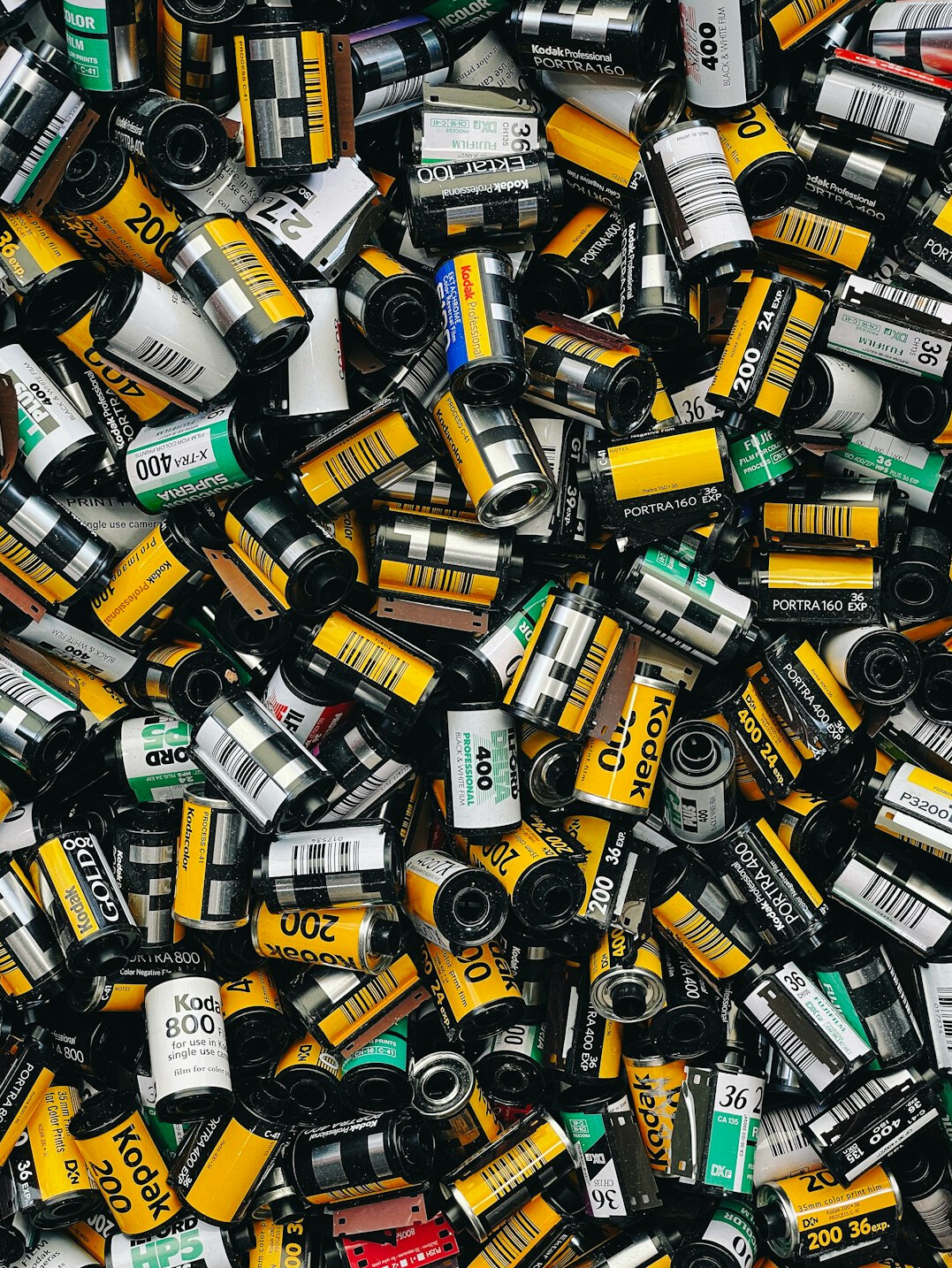Camera equipment and film rolls on a wooden desk